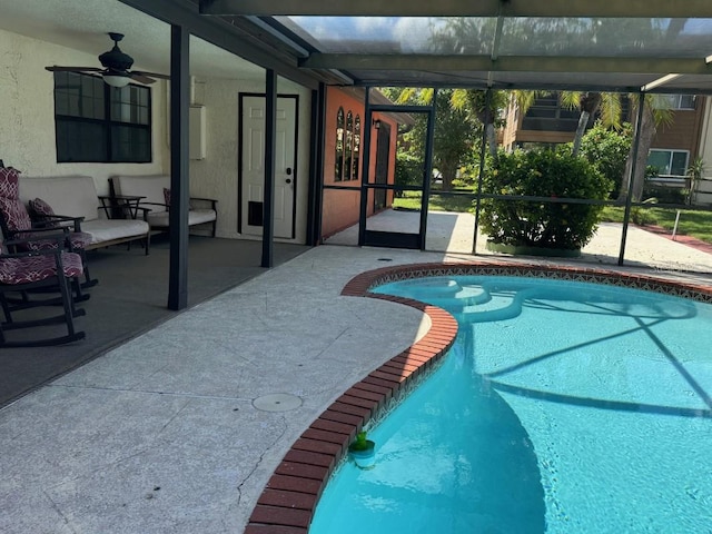 view of pool featuring ceiling fan, a lanai, and a patio