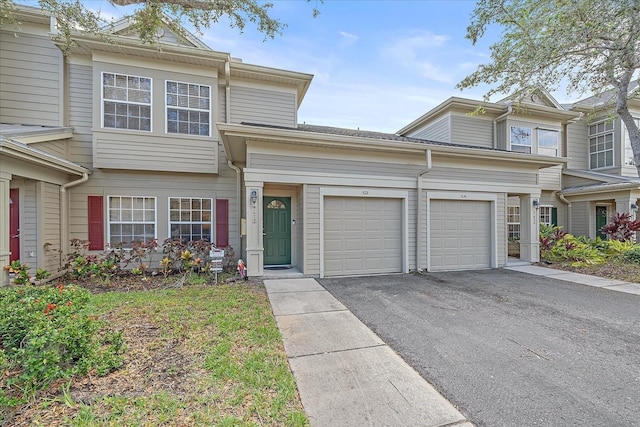 multi unit property featuring a garage