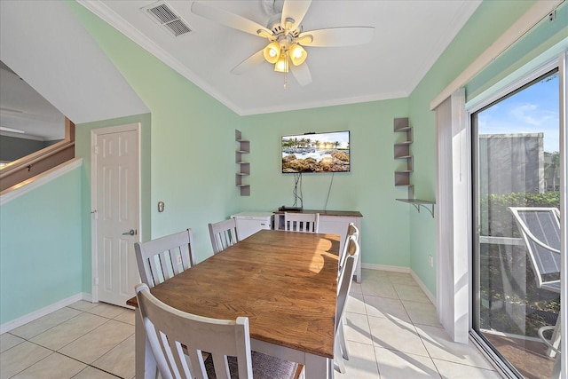 dining area with ceiling fan, crown molding, and light tile patterned floors