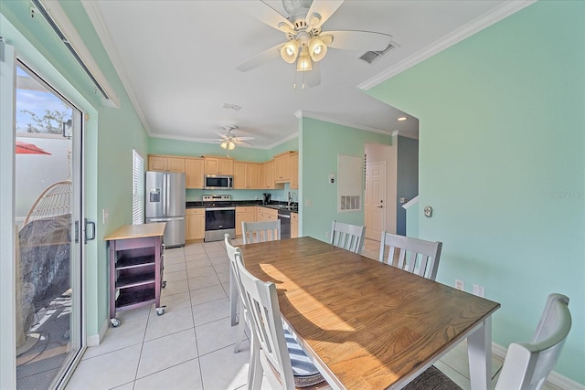 tiled dining space featuring ceiling fan, ornamental molding, and sink