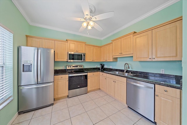 kitchen featuring appliances with stainless steel finishes, light brown cabinets, ornamental molding, and sink