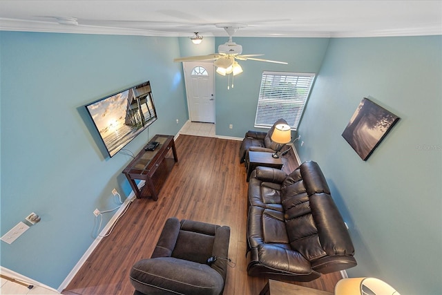 living room featuring hardwood / wood-style flooring, ceiling fan, and crown molding