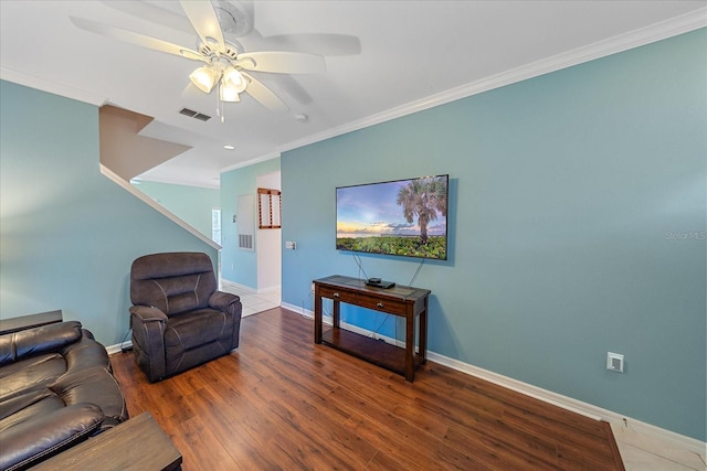 living room featuring ceiling fan, wood-type flooring, and ornamental molding