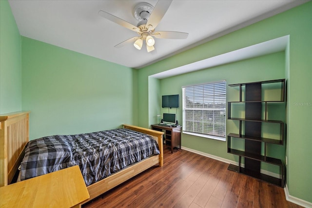 bedroom with ceiling fan and dark hardwood / wood-style floors