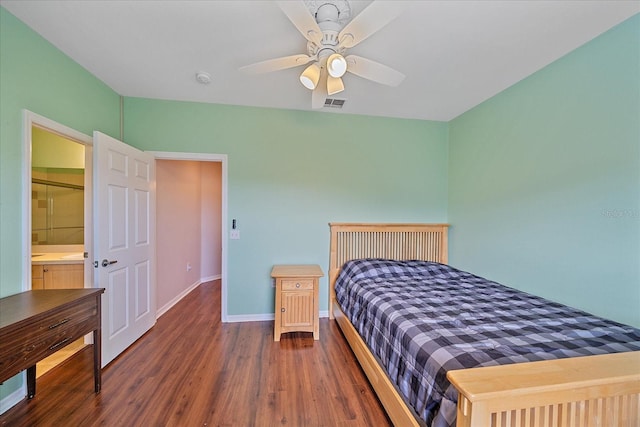 bedroom featuring ensuite bath, ceiling fan, and dark wood-type flooring