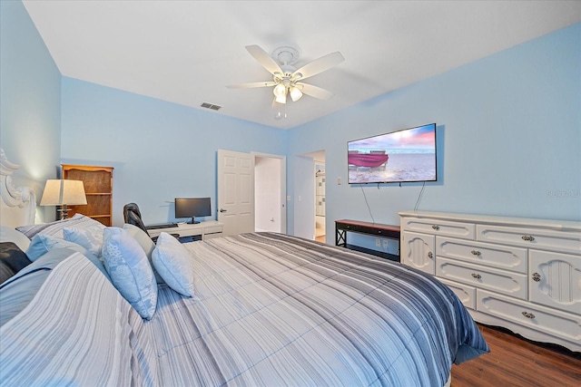 bedroom with dark hardwood / wood-style floors, ceiling fan, and ensuite bathroom