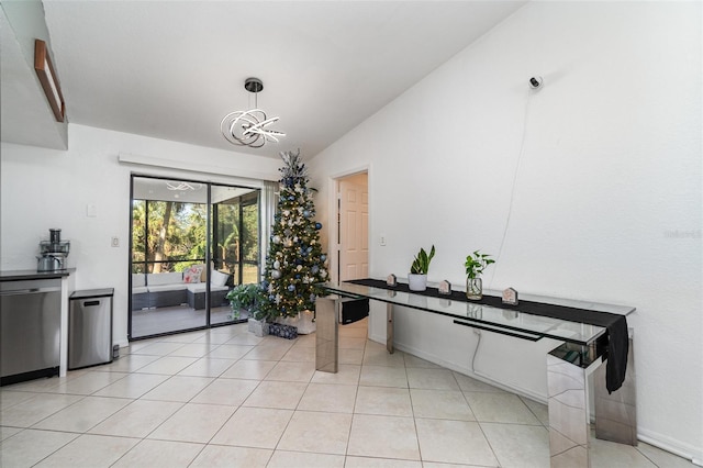 tiled dining space with an inviting chandelier and vaulted ceiling