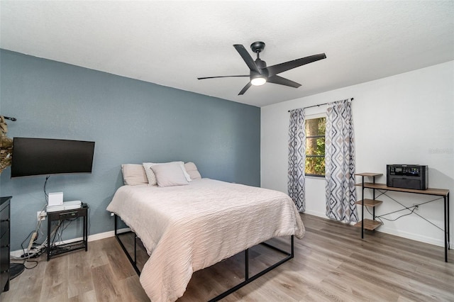 bedroom with hardwood / wood-style flooring and ceiling fan