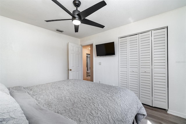 bedroom with a closet, ceiling fan, and hardwood / wood-style floors