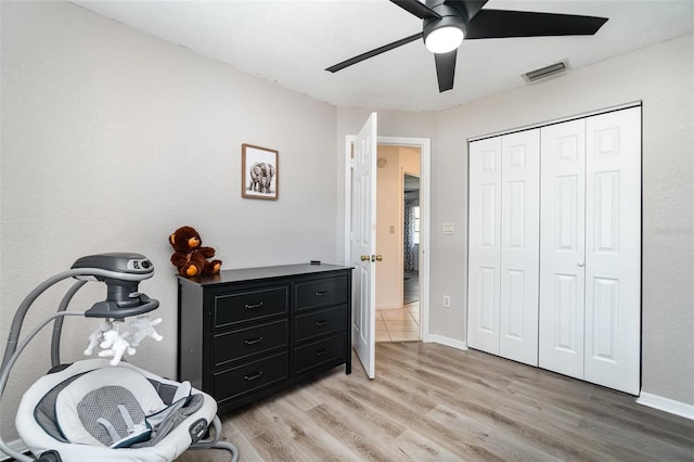 bedroom featuring light wood-type flooring, a closet, and ceiling fan