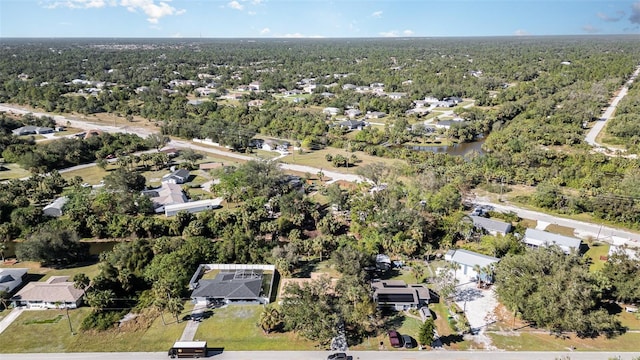 aerial view featuring a wooded view and a residential view