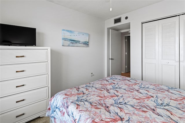 bedroom with a textured ceiling and a closet