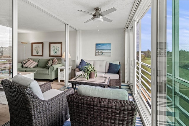 sunroom / solarium featuring ceiling fan