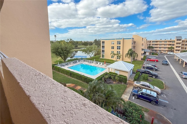 view of swimming pool featuring a water view