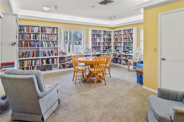 sitting room featuring carpet floors and a textured ceiling