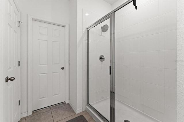 bathroom with tile patterned floors and a shower with shower door