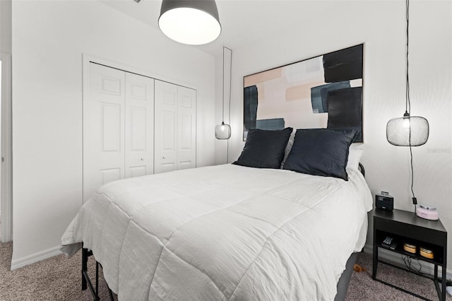 bedroom featuring dark colored carpet and a closet