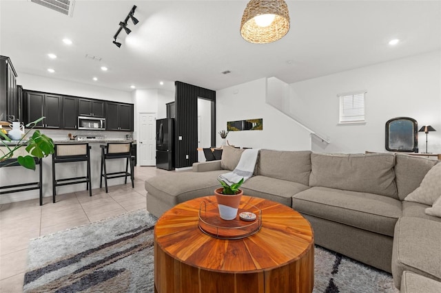 living room with light tile patterned floors and track lighting