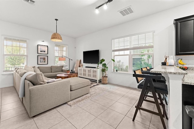 tiled living room with rail lighting