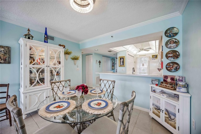 dining room featuring a textured ceiling, ceiling fan, light tile patterned floors, and crown molding