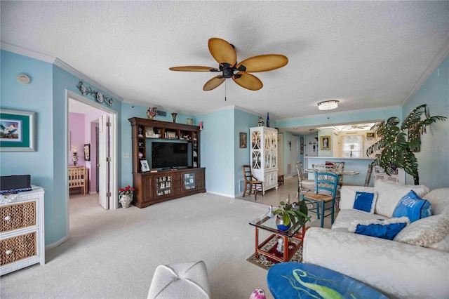 living room with carpet flooring, ceiling fan, a textured ceiling, and ornamental molding