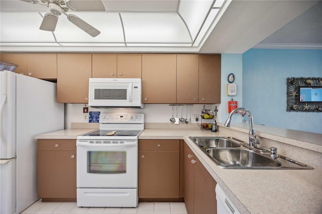 kitchen featuring white appliances, sink, ceiling fan, light tile patterned floors, and ornamental molding