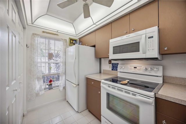 kitchen featuring ceiling fan, white appliances, and light tile patterned floors