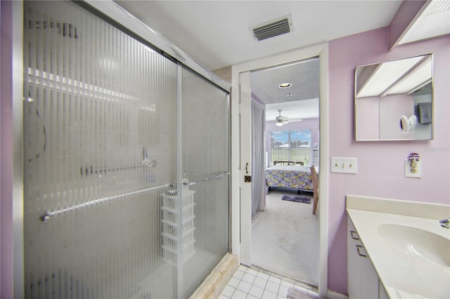 bathroom featuring vanity, tile patterned floors, and an enclosed shower