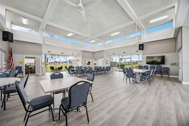 dining room featuring light wood-type flooring, plenty of natural light, and ceiling fan