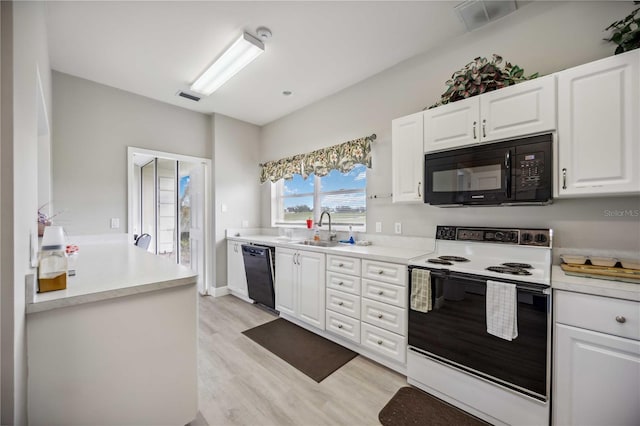 kitchen with black appliances, light hardwood / wood-style floors, white cabinets, and sink