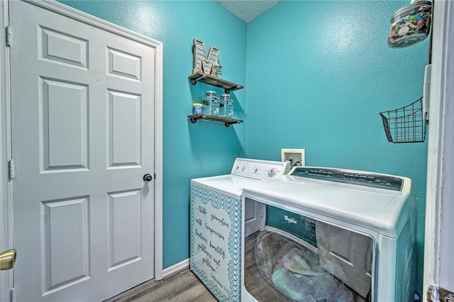 laundry room featuring washer and dryer and light wood-type flooring