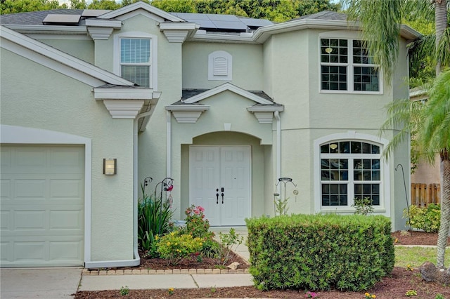 view of exterior entry with a garage