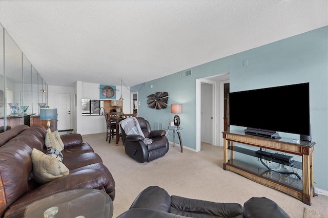 carpeted living room with a textured ceiling