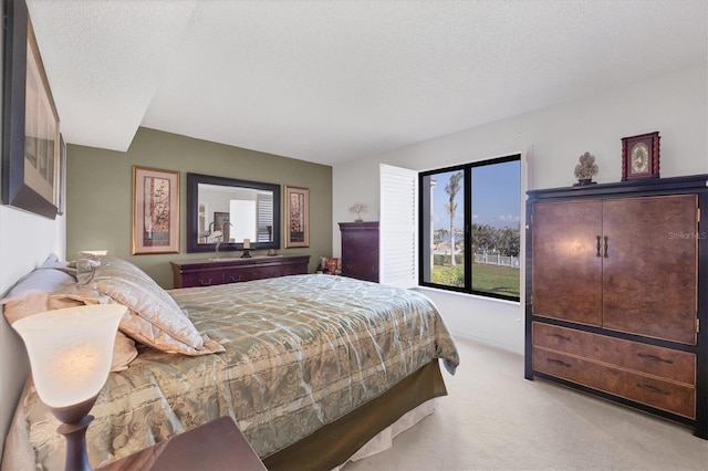 bedroom featuring a textured ceiling and light colored carpet