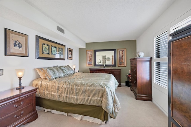 carpeted bedroom featuring a textured ceiling