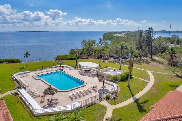 view of pool with a water view and a patio area