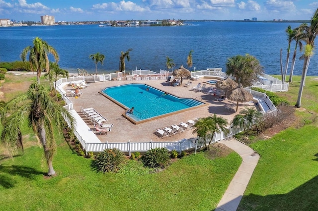 view of pool featuring a water view and a patio area