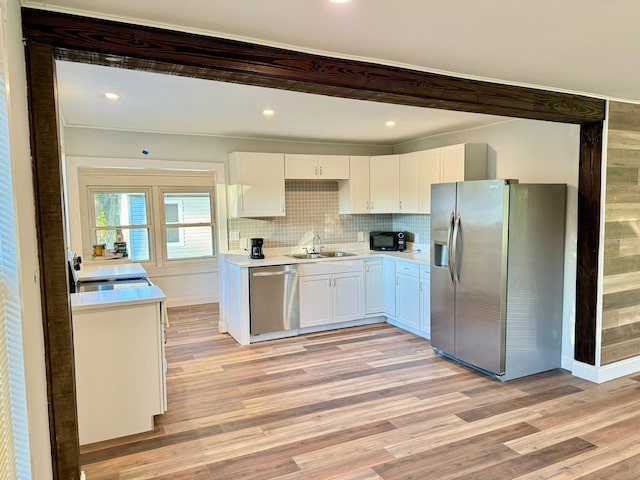 kitchen featuring light hardwood / wood-style floors, sink, white cabinetry, and stainless steel appliances