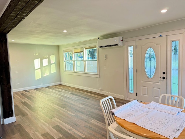 foyer with hardwood / wood-style floors and a wall mounted air conditioner