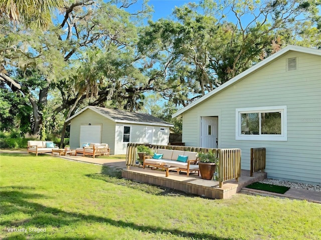 rear view of property featuring an outdoor hangout area, an outdoor structure, and a lawn