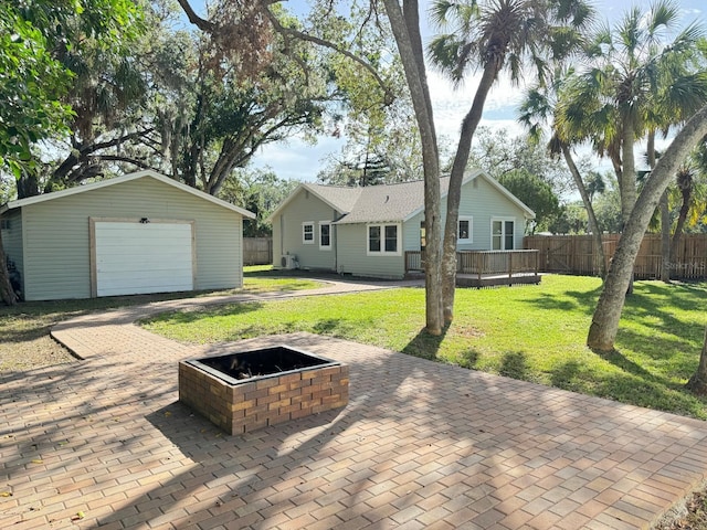 exterior space with a deck, a garage, and an outdoor structure