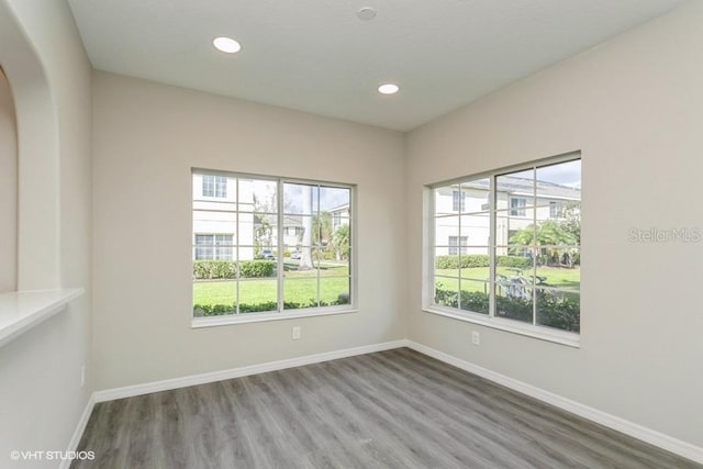 unfurnished room with hardwood / wood-style flooring