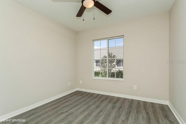 empty room with ceiling fan and dark hardwood / wood-style floors