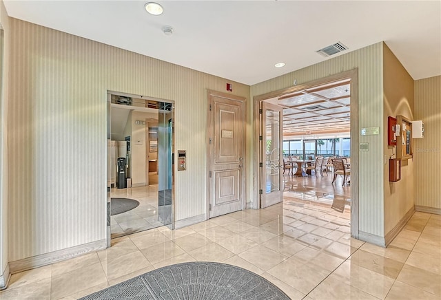 hallway featuring light tile patterned floors