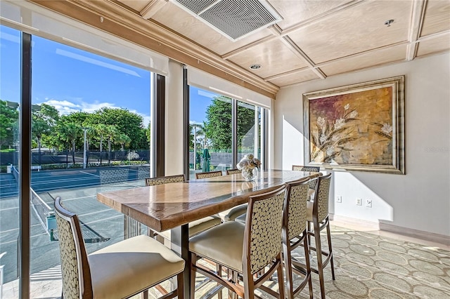 dining space featuring coffered ceiling