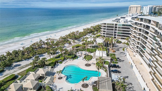 aerial view with a water view and a beach view