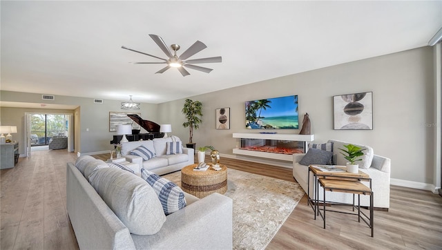 living room featuring light wood-type flooring and ceiling fan