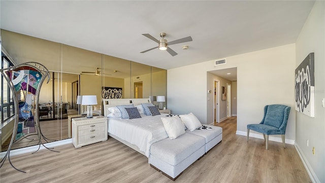 bedroom with light hardwood / wood-style floors and ceiling fan