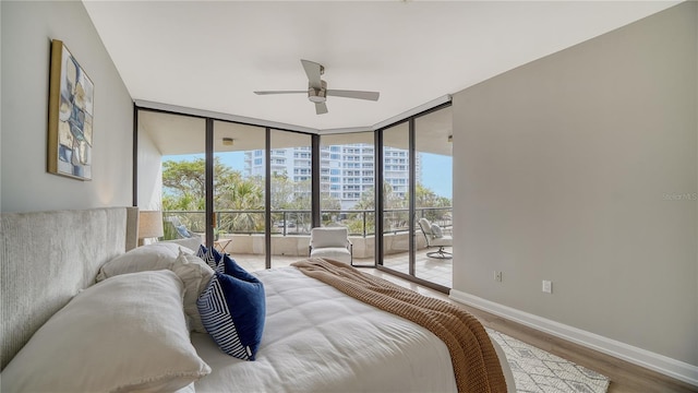 bedroom with hardwood / wood-style floors, ceiling fan, floor to ceiling windows, and access to exterior