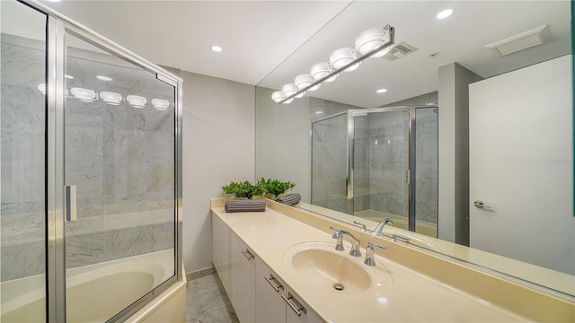 bathroom with combined bath / shower with glass door and vanity